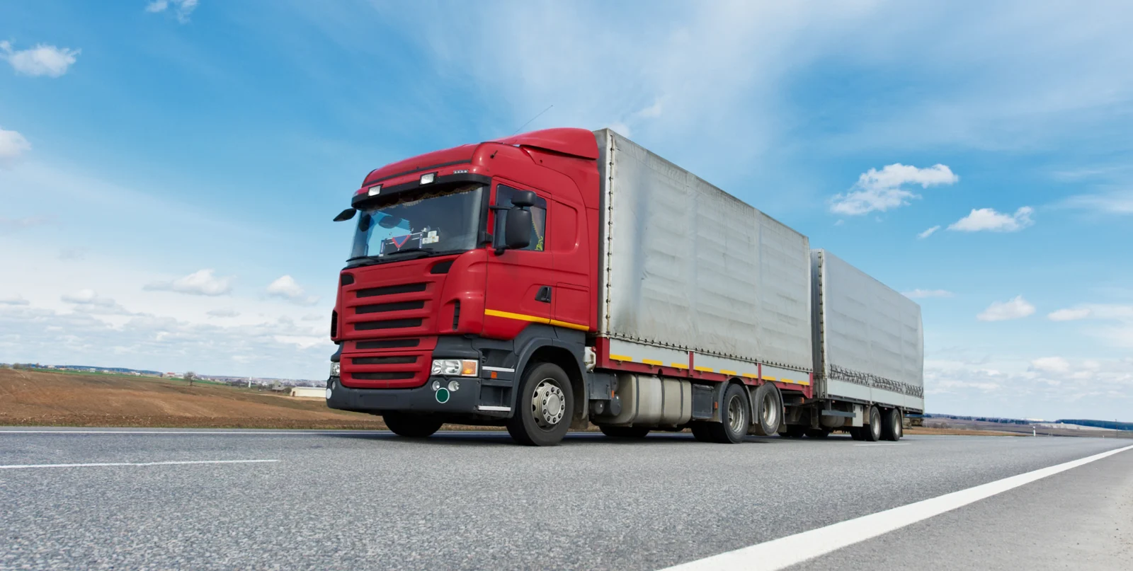 Red commercial truck on the open road